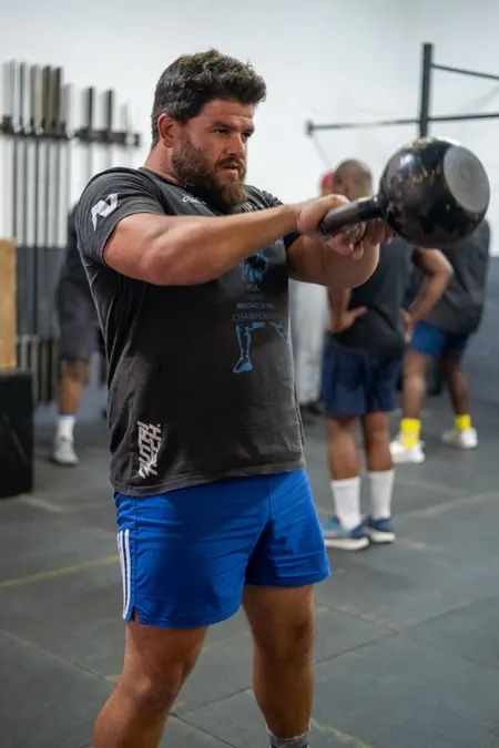Jonathan Raphael swinging a kettlebell