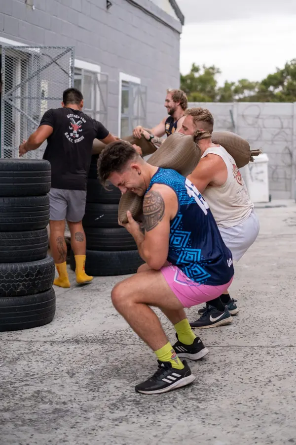 Sandbag squats outside Unit 16B